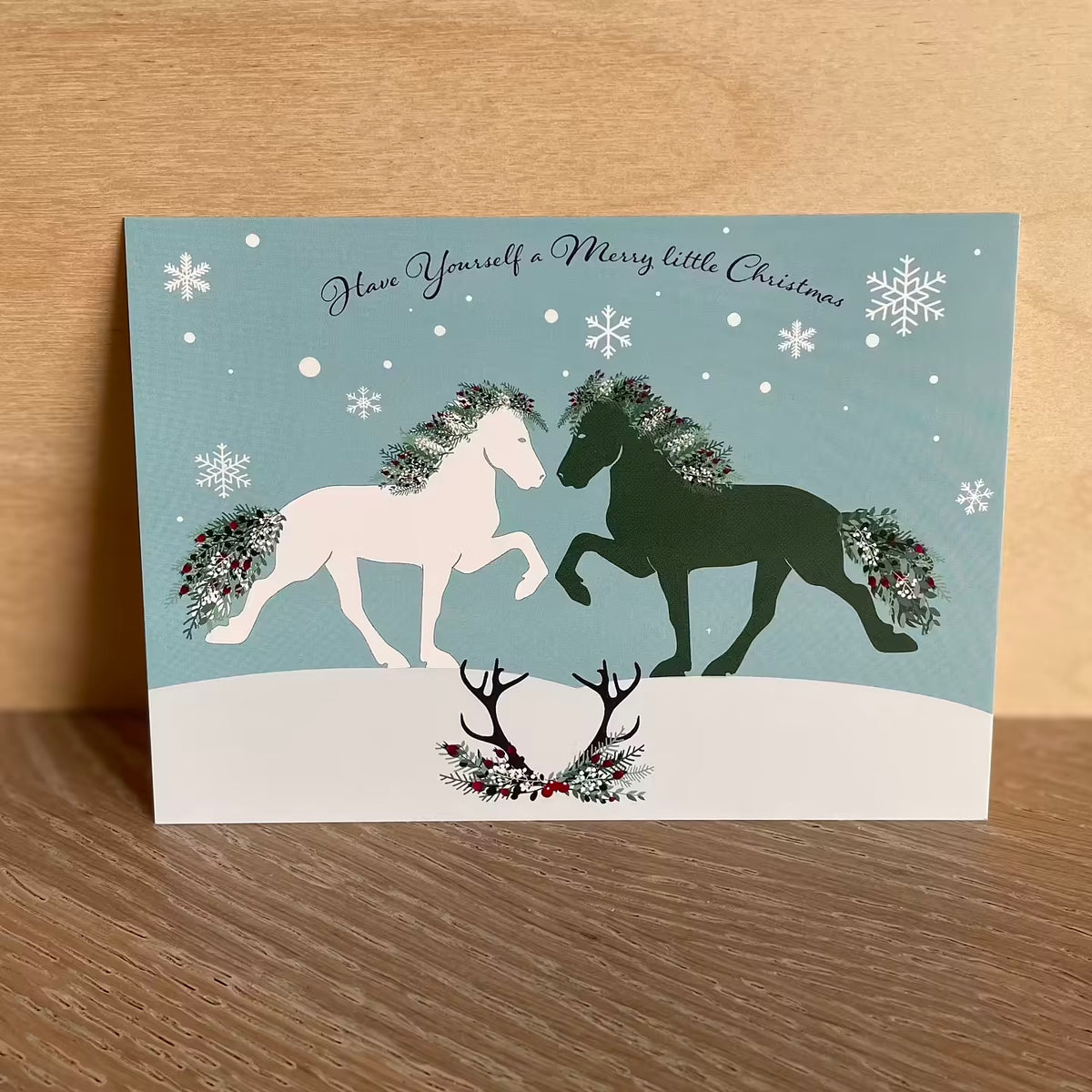 Postkort med julemotiv med to springende hester, 4-pakning